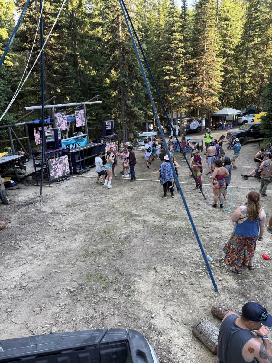 The full festival site in daylight - rig, crowd and forest