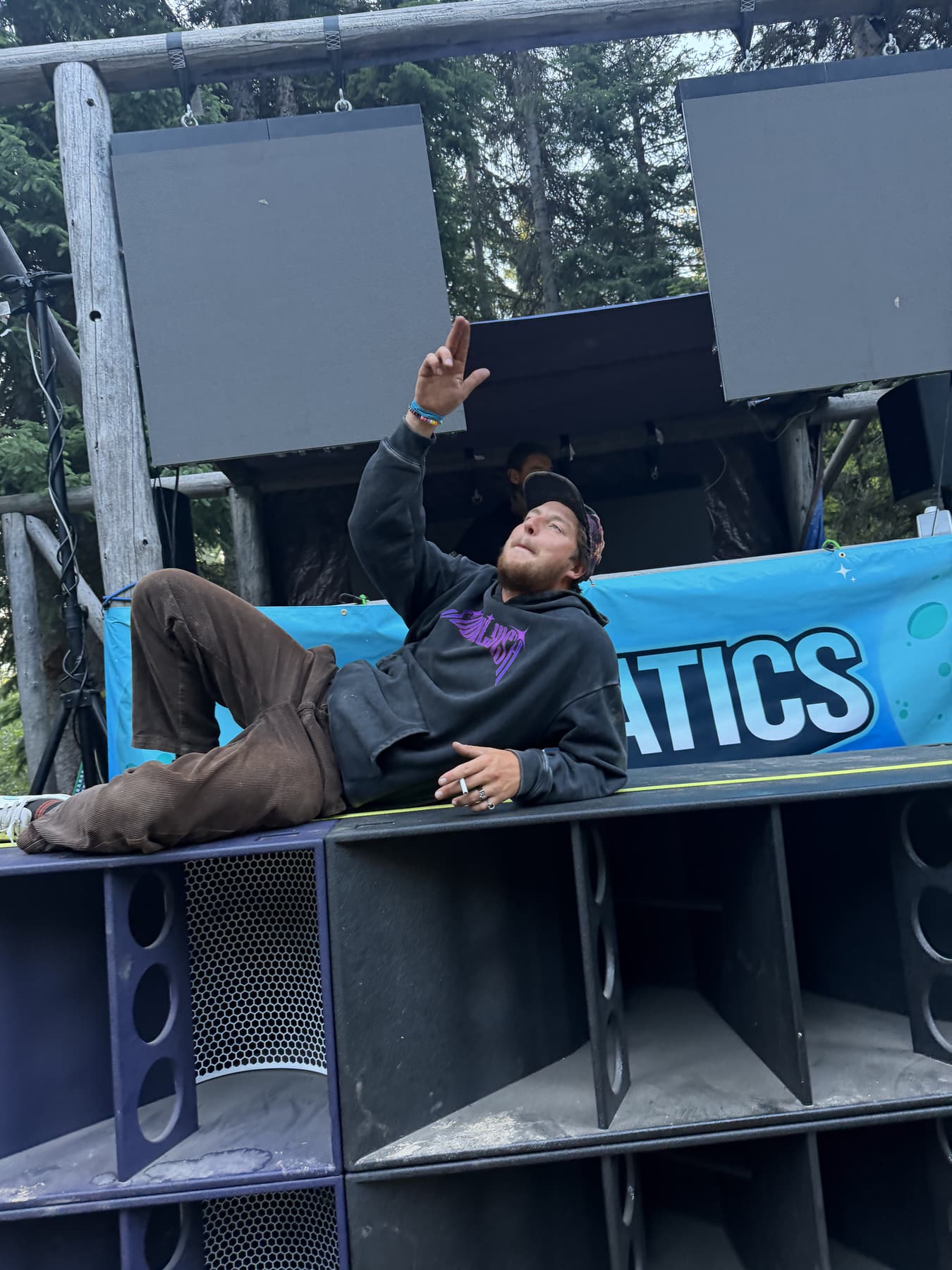 Jackson lying across the top of the speaker stack, finger guns up