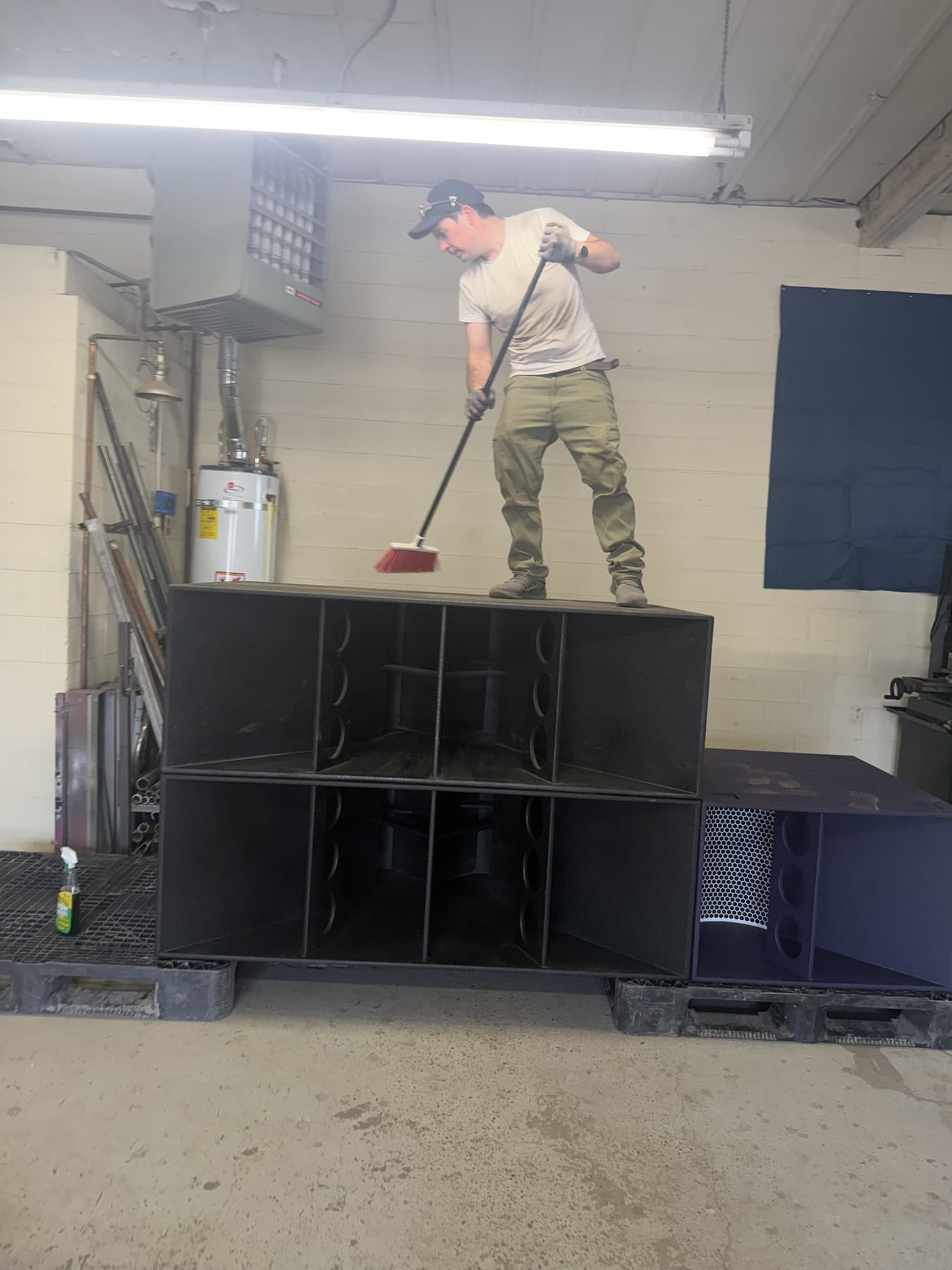 Calen sweeping the top of a Funktion-One sub in the shop